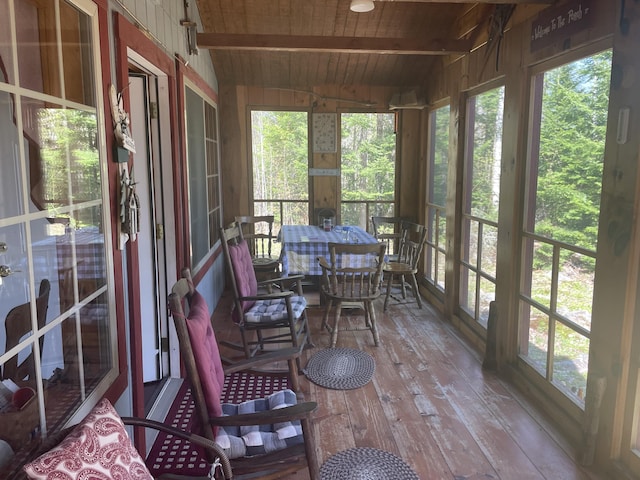 sunroom featuring hardwood / wood-style flooring, wood ceiling, and plenty of natural light