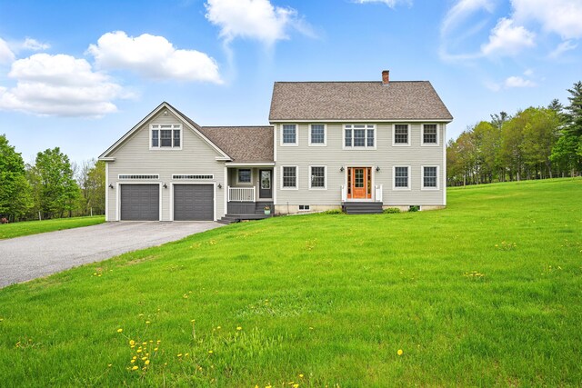 94 Staples Hill Rd, Canton, ME 04221 - colonial house featuring asphalt driveway, a chimney, a front lawn, a shingled roof, and a garage