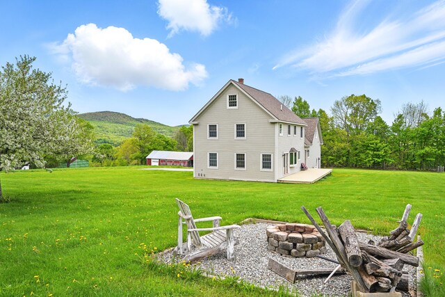94 Staples Hill Rd, Canton, ME 04221 - back of property featuring a fire pit, a chimney, a lawn, and a mountain view