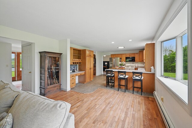 94 Staples Hill Rd, Canton, ME 04221 - kitchen with stainless steel fridge, black microwave, open floor plan, white stove, and a peninsula
