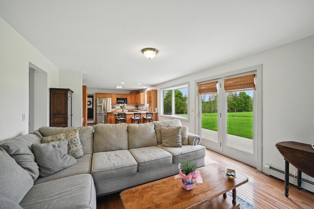 94 Staples Hill Rd, Canton, ME 04221 - living room with a baseboard heating unit, light wood-style flooring, and recessed lighting