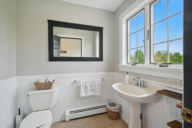94 Staples Hill Rd, Canton, ME 04221 - bathroom with baseboard heating, a wainscoted wall, toilet, tile patterned flooring, and a sink