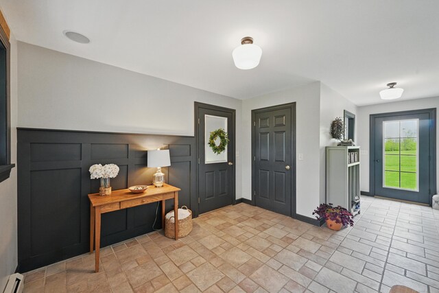 94 Staples Hill Rd, Canton, ME 04221 - entrance foyer with baseboard heating and light stone finish flooring