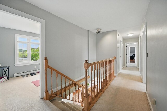 94 Staples Hill Rd, Canton, ME 04221 - corridor featuring an upstairs landing, carpet floors, baseboard heating, and baseboards