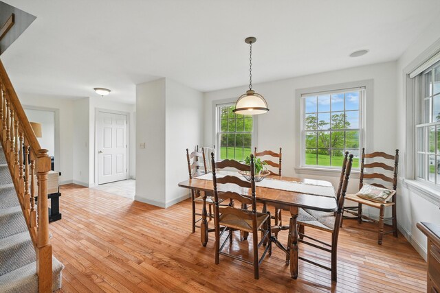 94 Staples Hill Rd, Canton, ME 04221 - dining space with stairway, light wood-style flooring, and baseboards