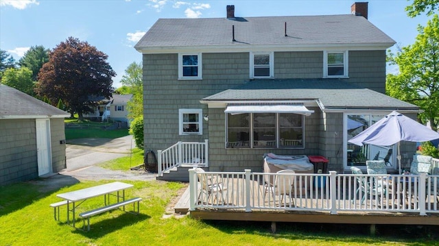 139 S Ave, Lewiston, ME 04240 - back of house featuring roof with shingles, a chimney, a lawn, and a wooden deck