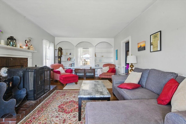 139 S Ave, Lewiston, ME 04240 - living room featuring wood finished floors, a fireplace, and built in features