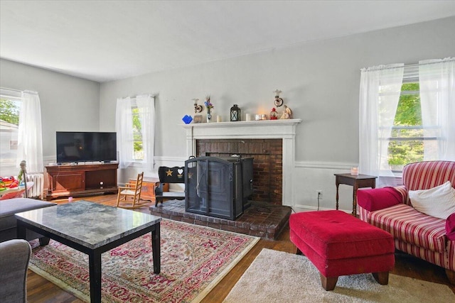 139 S Ave, Lewiston, ME 04240 - living room with healthy amount of natural light, radiator heating unit, wood finished floors, and wainscoting