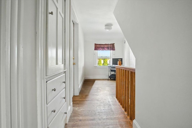 139 S Ave, Lewiston, ME 04240 - hallway with light wood-type flooring, a desk, and baseboards