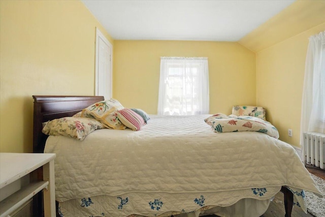 139 S Ave, Lewiston, ME 04240 - bedroom featuring radiator heating unit, wood finished floors, and lofted ceiling