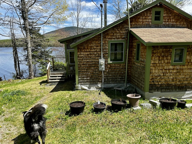 1080 Frenchtown Rd, Frenchtown Twp, ME 04441 - view of side of property with a deck with mountain view, a lawn, and a shingled roof