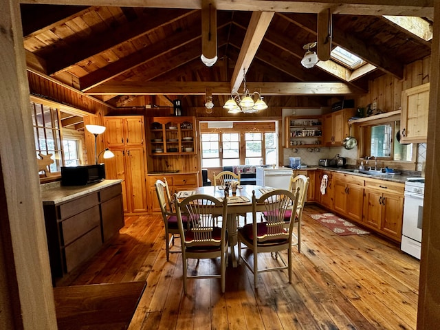 1080 Frenchtown Rd, Frenchtown Twp, ME 04441 - dining area with wooden ceiling, wood-type flooring, wooden walls, plenty of natural light, and a skylight