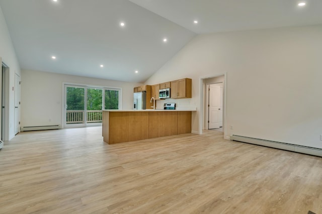 324 Gray Rd, Shapleigh, ME 04076 - kitchen with stainless steel appliances, baseboard heating, brown cabinets, a peninsula, and open floor plan