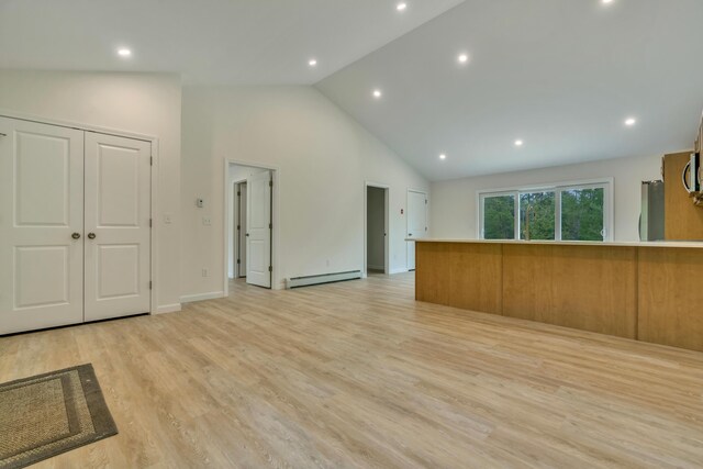 324 Gray Rd, Shapleigh, ME 04076 - unfurnished living room featuring a baseboard radiator, high vaulted ceiling, light wood-type flooring, recessed lighting, and baseboards