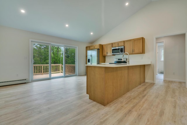 324 Gray Rd, Shapleigh, ME 04076 - kitchen featuring appliances with stainless steel finishes, brown cabinets, a peninsula, light countertops, and light wood-style floors