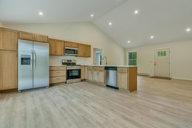 324 Gray Rd, Shapleigh, ME 04076 - kitchen with appliances with stainless steel finishes, light countertops, a peninsula, light wood finished floors, and high vaulted ceiling