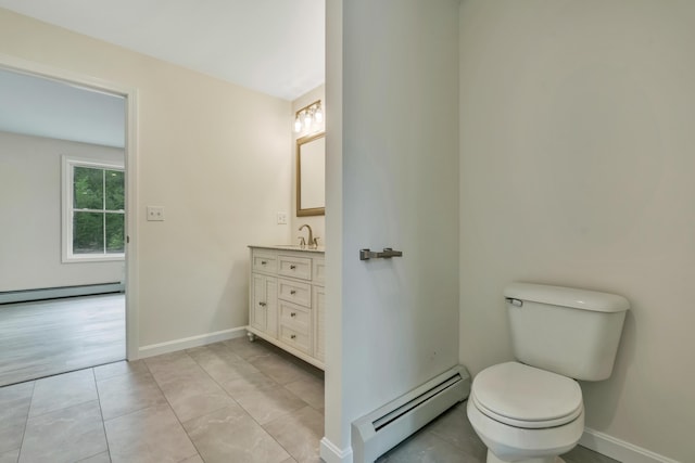 324 Gray Rd, Shapleigh, ME 04076 - bathroom with a baseboard radiator, baseboard heating, vanity, toilet, and baseboards
