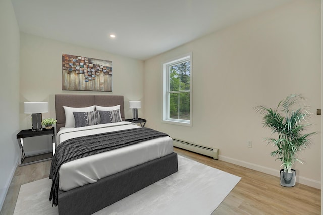 324 Gray Rd, Shapleigh, ME 04076 - bedroom featuring a baseboard heating unit, wood finished floors, baseboards, and recessed lighting