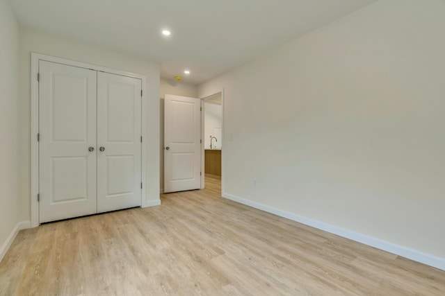 324 Gray Rd, Shapleigh, ME 04076 - unfurnished bedroom with baseboards, light wood-style flooring, a closet, and recessed lighting