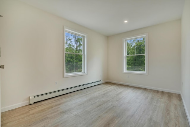 324 Gray Rd, Shapleigh, ME 04076 - empty room with a baseboard heating unit, plenty of natural light, wood finished floors, baseboards, and recessed lighting