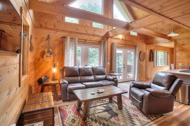 231 Kendall Farm Trl, Rangeley, ME 04970 - living area with french doors, wood walls, beamed ceiling, hardwood / wood-style flooring, and high vaulted ceiling