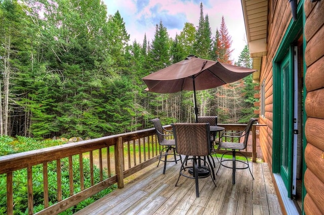231 Kendall Farm Trl, Rangeley, ME 04970 - wooden terrace with outdoor dining space