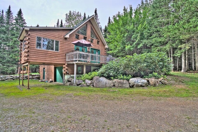 231 Kendall Farm Trl, Rangeley, ME 04970 - rear view of house with log siding, a deck, and a garage