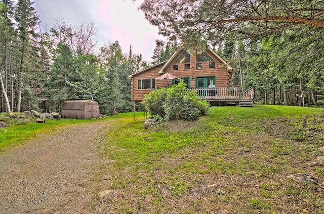 231 Kendall Farm Trl, Rangeley, ME 04970 - view of front of property featuring log exterior, a shed, a deck, an outbuilding, and a front lawn