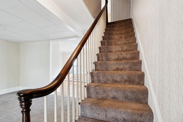 stairway with carpet floors, baseboards, and wallpapered walls