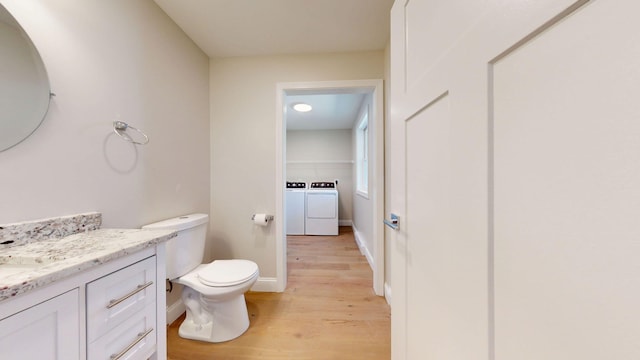 9 Country Dr, Old Orchard Beach, ME 04064 - bathroom featuring wood finished floors, washer and clothes dryer, vanity, toilet, and baseboards