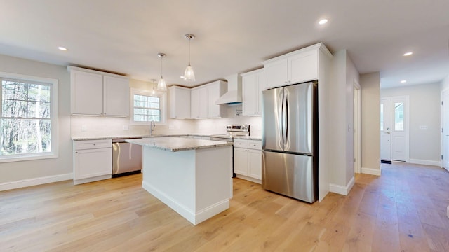 9 Country Dr, Old Orchard Beach, ME 04064 - kitchen featuring stainless steel appliances, premium range hood, tasteful backsplash, light wood finished floors, and recessed lighting