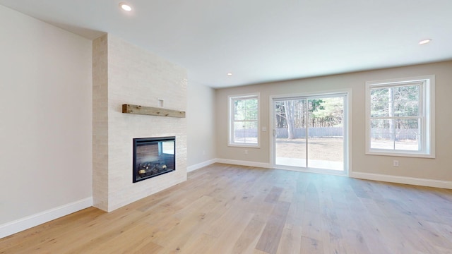 9 Country Dr, Old Orchard Beach, ME 04064 - unfurnished living room featuring light wood-type flooring, healthy amount of natural light, a large fireplace, and recessed lighting