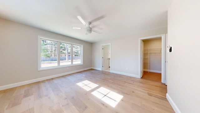 9 Country Dr, Old Orchard Beach, ME 04064 - unfurnished bedroom with light wood-style flooring, a walk in closet, baseboards, and a closet
