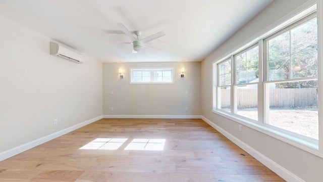 9 Country Dr, Old Orchard Beach, ME 04064 - empty room featuring a wall mounted AC, light wood-style floors, ceiling fan, and baseboards