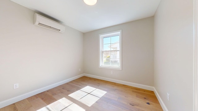 9 Country Dr, Old Orchard Beach, ME 04064 - unfurnished room with a wall mounted AC, light wood finished floors, and baseboards