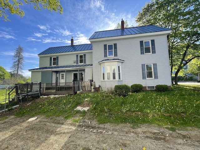 172 Highland Ave, Gardiner, ME 04345 - rear view of property featuring a standing seam roof, a chimney, and metal roof