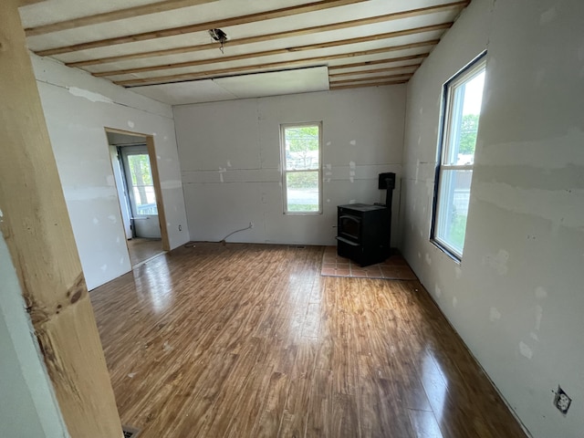 172 Highland Ave, Gardiner, ME 04345 - spare room featuring wood finished floors and a wood stove