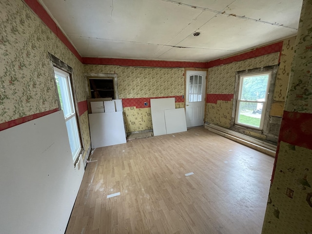 172 Highland Ave, Gardiner, ME 04345 - spare room with wallpapered walls, wainscoting, light wood finished floors, and healthy amount of natural light