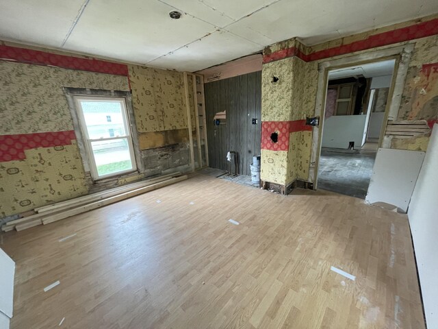 172 Highland Ave, Gardiner, ME 04345 - unfurnished living room featuring wallpapered walls and wood finished floors