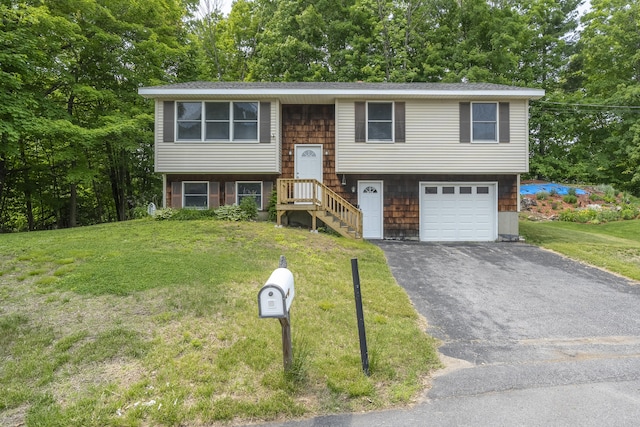 32 Thorne Ave, Lewiston, ME 04240 - split foyer home with driveway, a front lawn, a garage, and view of wooded area