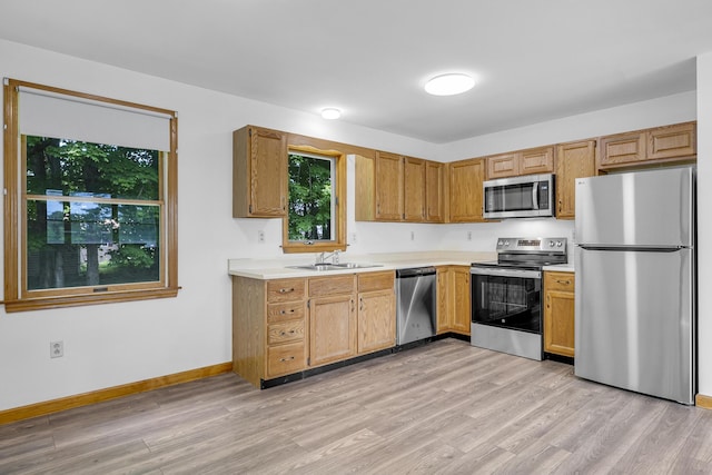 32 Thorne Ave, Lewiston, ME 04240 - kitchen featuring stainless steel appliances, a sink, light countertops, and light wood-style floors