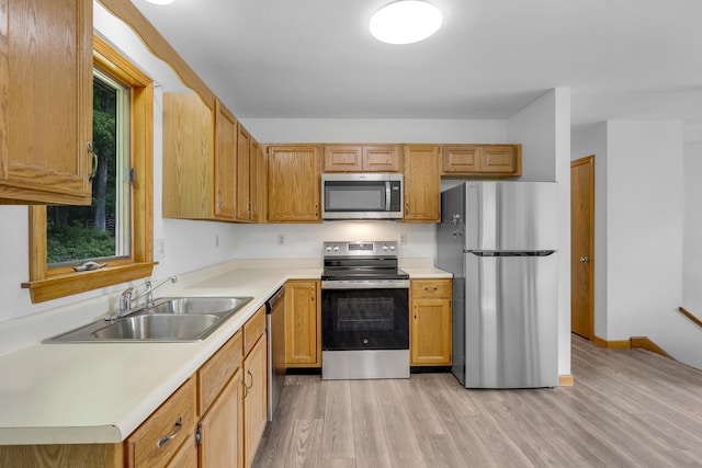32 Thorne Ave, Lewiston, ME 04240 - kitchen featuring stainless steel appliances, a sink, light wood-type flooring, light countertops, and baseboards