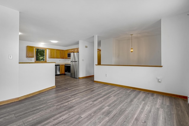 32 Thorne Ave, Lewiston, ME 04240 - unfurnished living room with dark wood-type flooring and baseboards