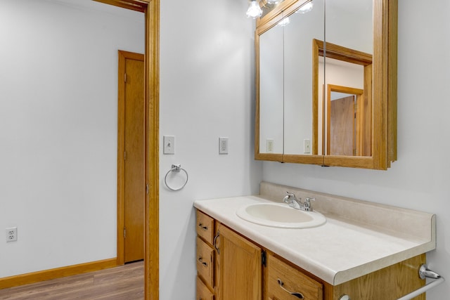 32 Thorne Ave, Lewiston, ME 04240 - bathroom featuring vanity, wood finished floors, and baseboards