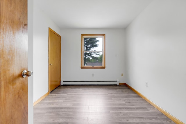 32 Thorne Ave, Lewiston, ME 04240 - unfurnished room with a baseboard radiator, light wood finished floors, and baseboards