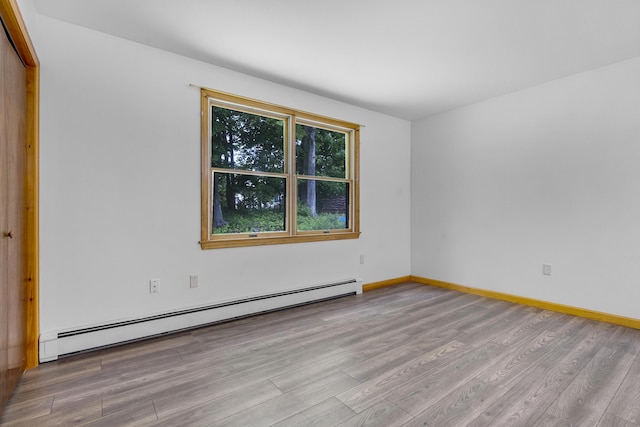 32 Thorne Ave, Lewiston, ME 04240 - unfurnished room with baseboard heating, wood finished floors, and baseboards