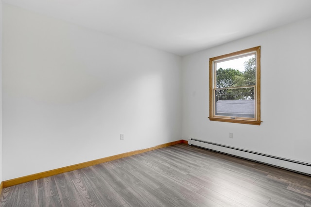 32 Thorne Ave, Lewiston, ME 04240 - spare room featuring a baseboard radiator, wood finished floors, and baseboards