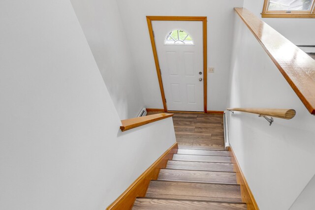 32 Thorne Ave, Lewiston, ME 04240 - staircase with wood finished floors, baseboards, and a baseboard radiator