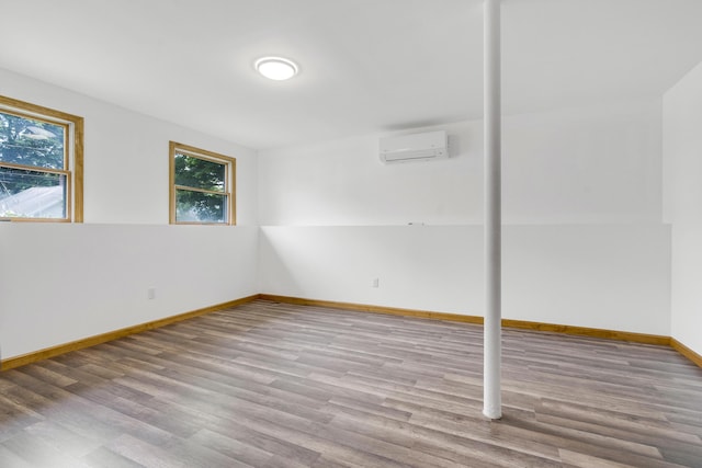 32 Thorne Ave, Lewiston, ME 04240 - below grade area with an AC wall unit, wood finished floors, and baseboards