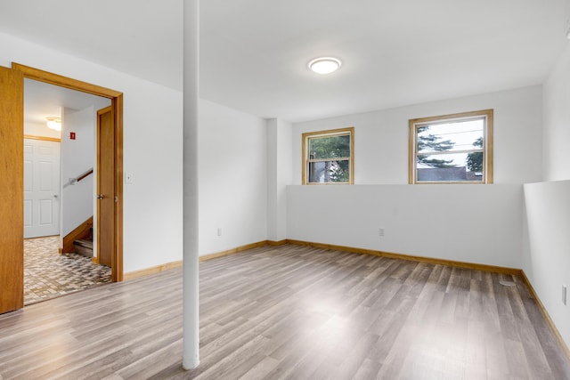 32 Thorne Ave, Lewiston, ME 04240 - unfurnished room with wood finished floors, baseboards, and stairway